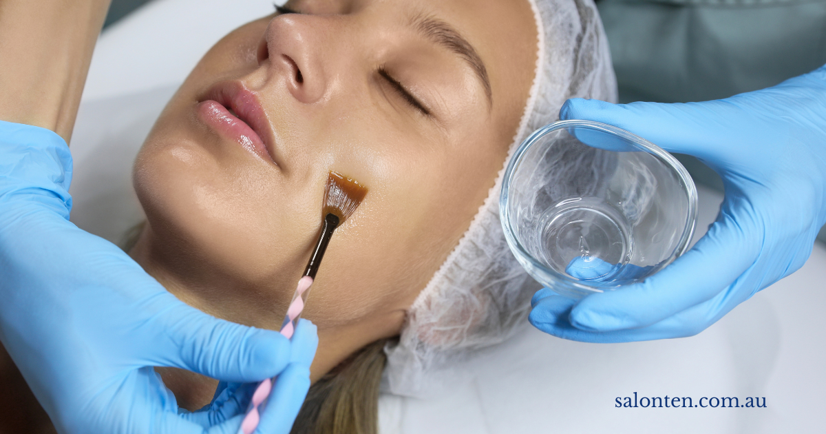 Clinical skin peel being applied with a brush during a facial treatment