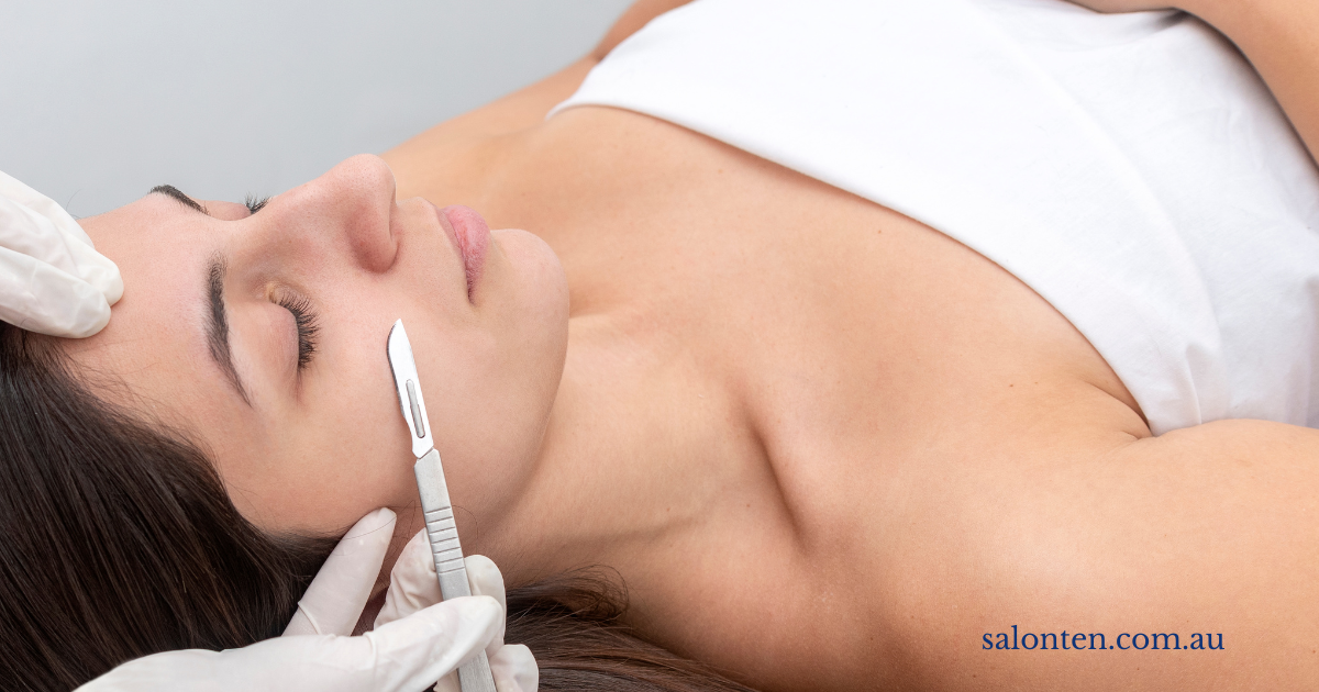 Dermaplaning blade being drawn across the cheek during a treatment